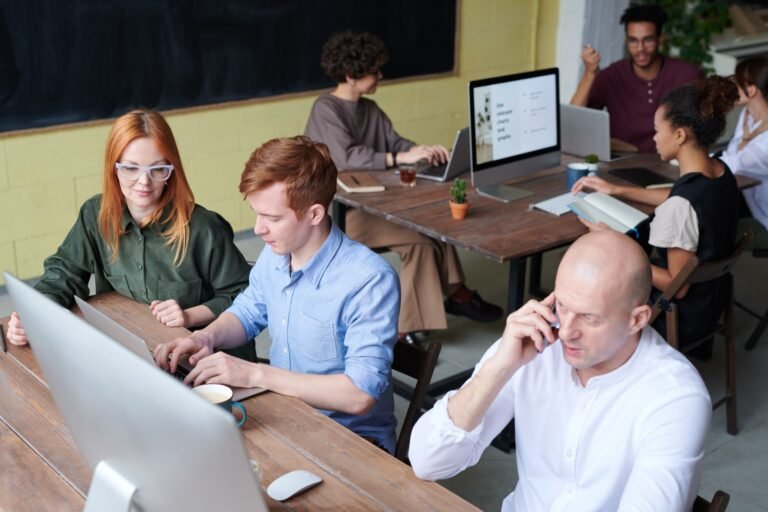 A busy team of professionals collaborating in a modern office space during the day.